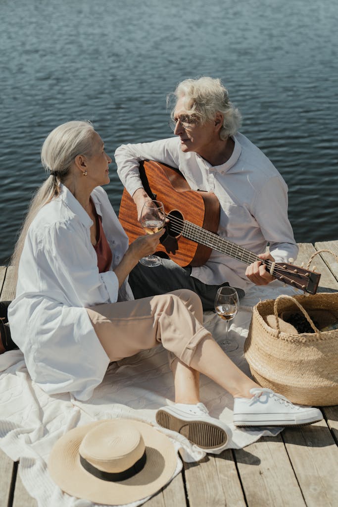 An Elderly Couple Sitting on a Wooden Dock